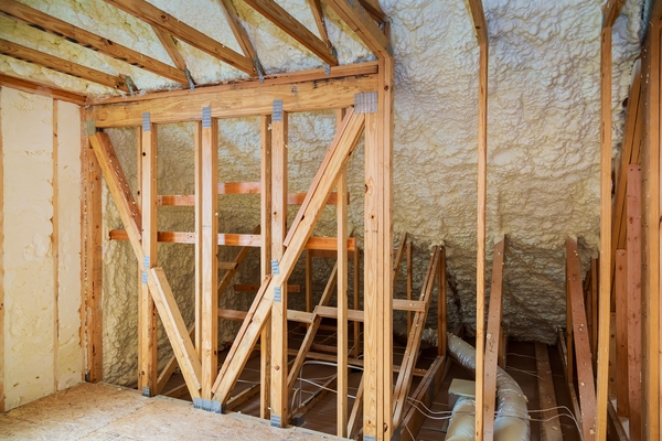 Travaux en cours avec projection d'isolant en vrac après devis isolation combles.